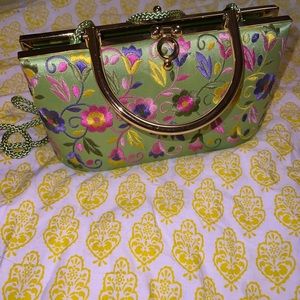 Cute clutch evening purse. Embroidery on the outside. Can go over shoulder